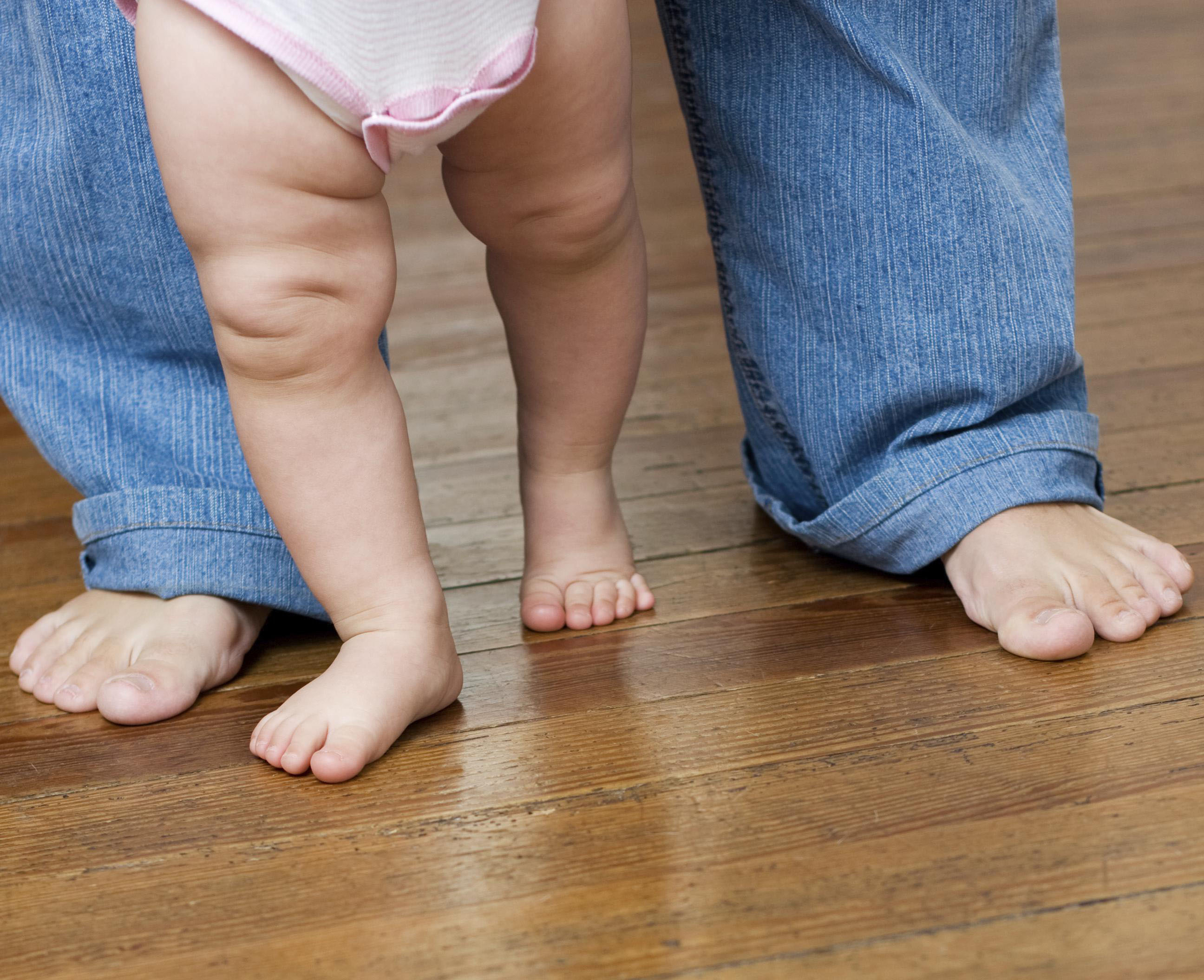 Baby walked on floor by parent