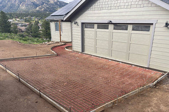 NeverFreeze Electric Snow and Ice Melt Radiant Heating cable being installed in various patterns on a driveway and walkway before pouring concrete on top