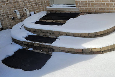 Rubber mats on stairway that has melted snow and ice